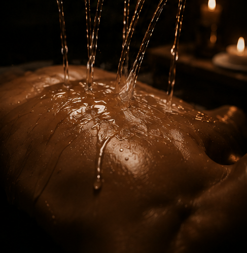 Warm streams cascading over the back in a candlelit ritual
